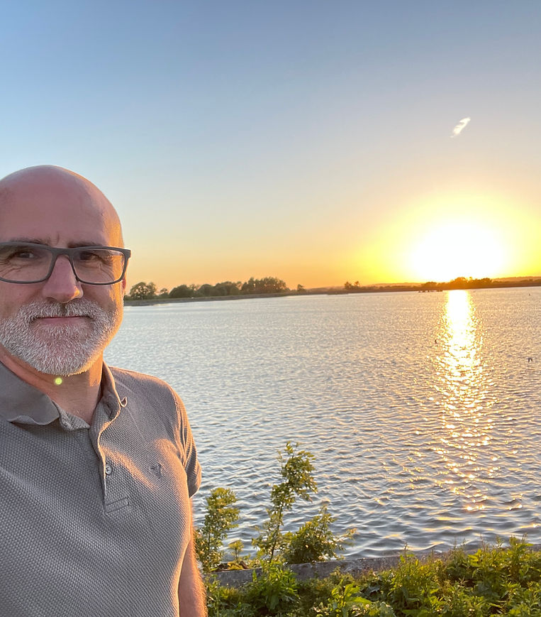 Andrew Bennett, founder of Kandryn Performance, beside a reservoir at sunset