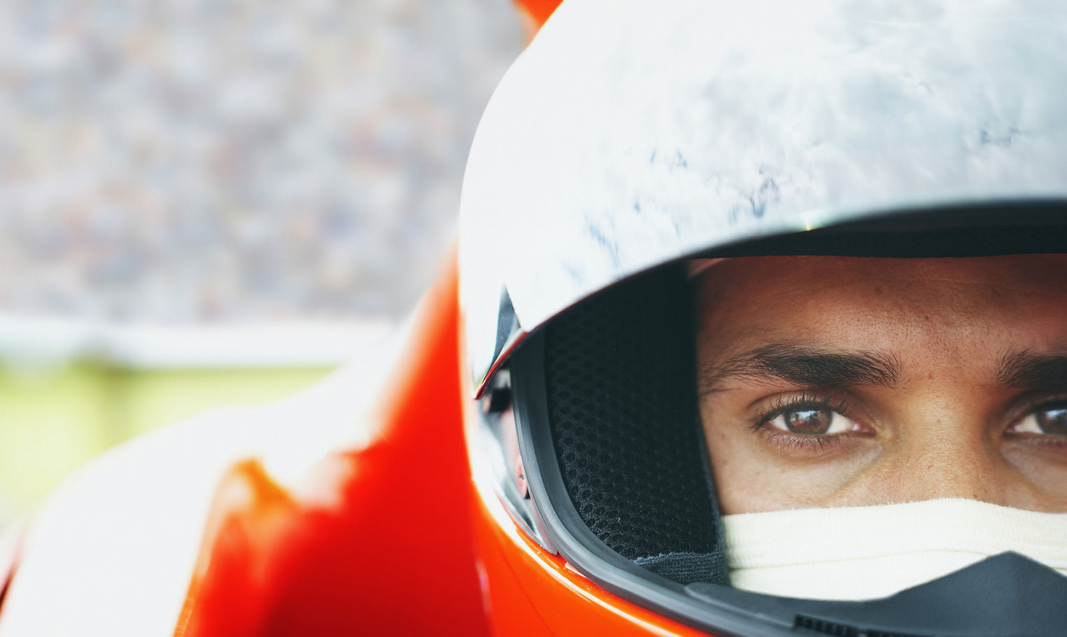 Close-up of a focused racing driver in a helmet, a nod to Ayrton Senna, whose belief in the power of the mind inspires the work behind Kandryn