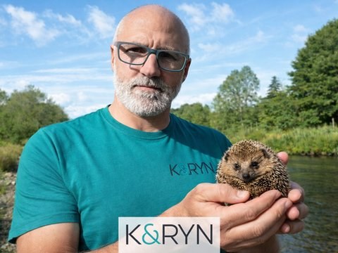 Andrew &ldquo;Diesel&rdquo; Bennett holding a hedgehog by a river