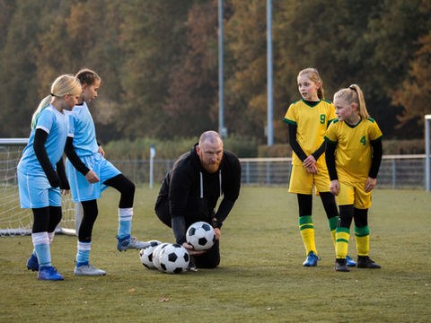 Andrew Bennett coaching young footballers on a pitch